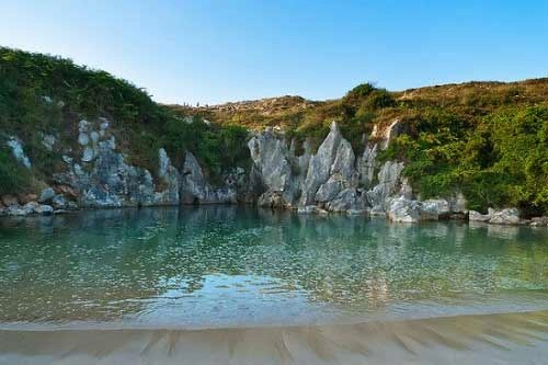 Bãi biển nằm giữa đồng cỏ xanh ở tây ban nha